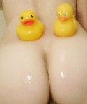 Emma has a shower with lots of bubbles and her rubber ducks